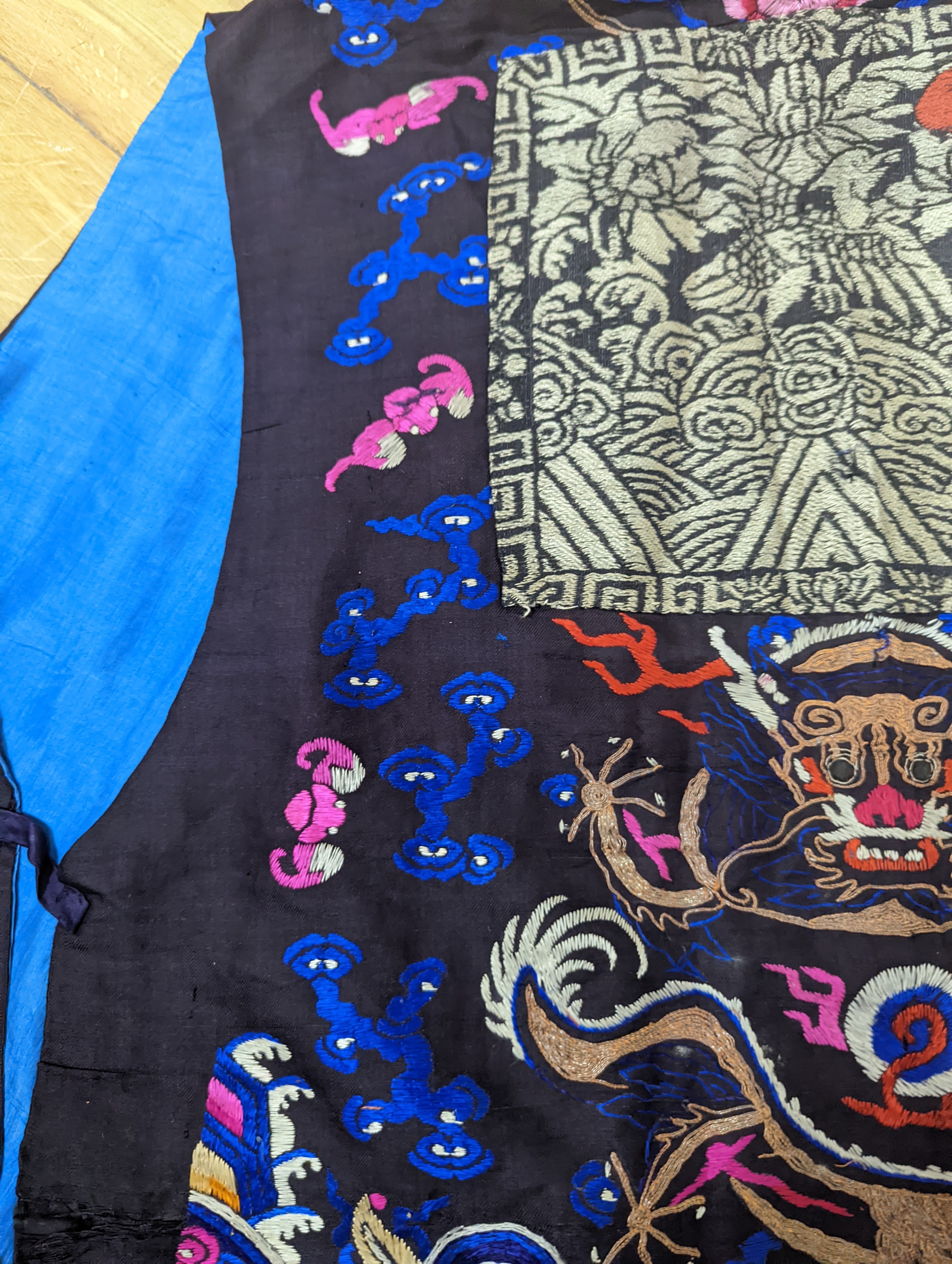 A 1920's Chinese dragon embroidered waistcoat, a cream silk drawn thread dress and a silk crepe black and patterned reversible kimono (3 items).